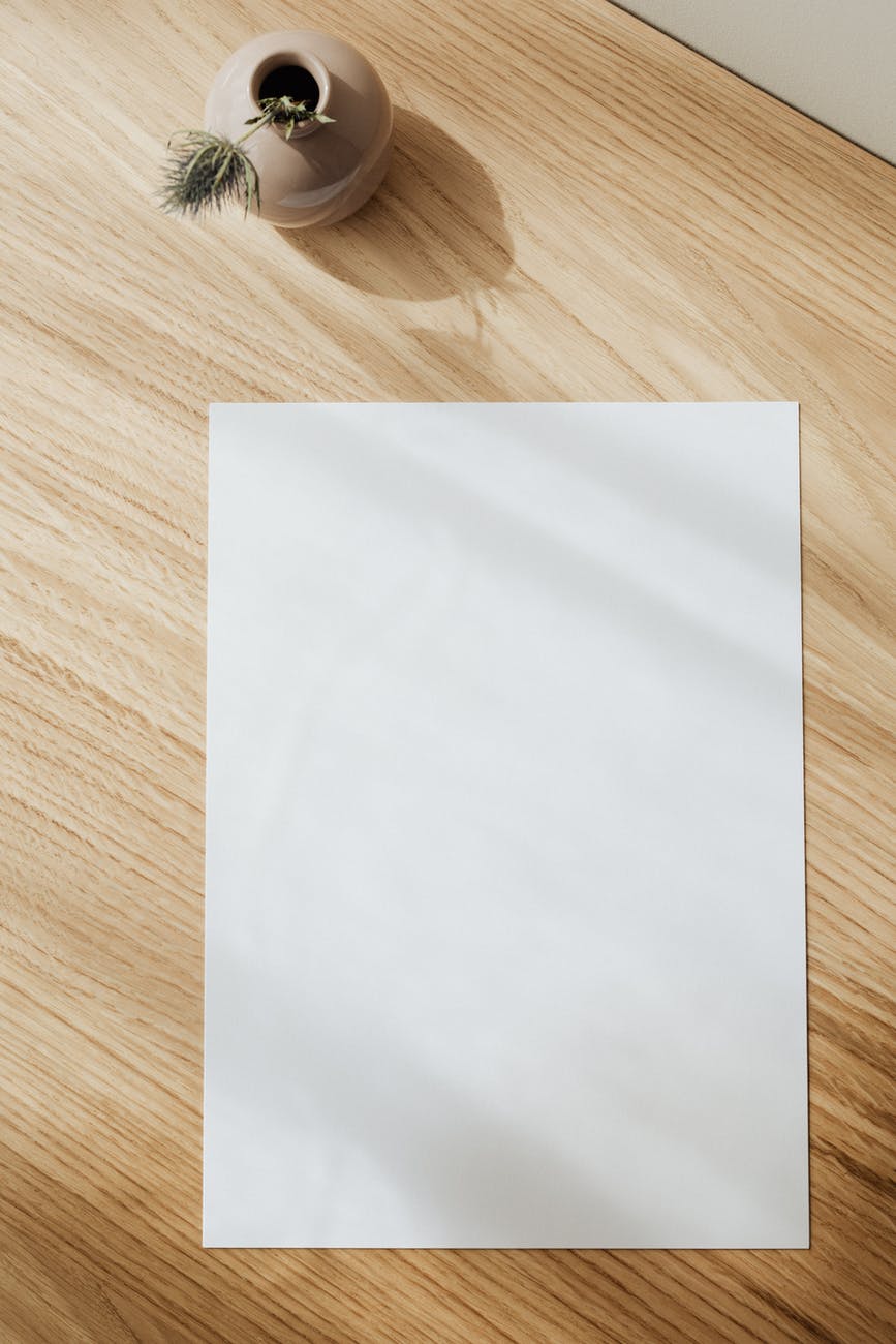 blank white paper sheet on wooden table