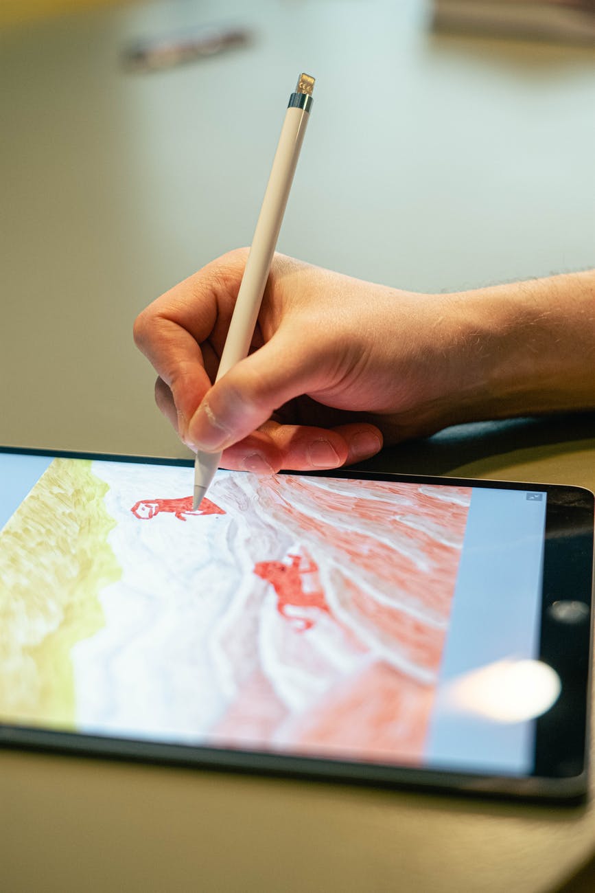 person sketching on a tablet